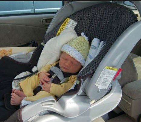 newborn baby sleeping in car seat