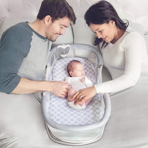 baby sleeping in SwaddleMe by Your Side Sleeper bassinet