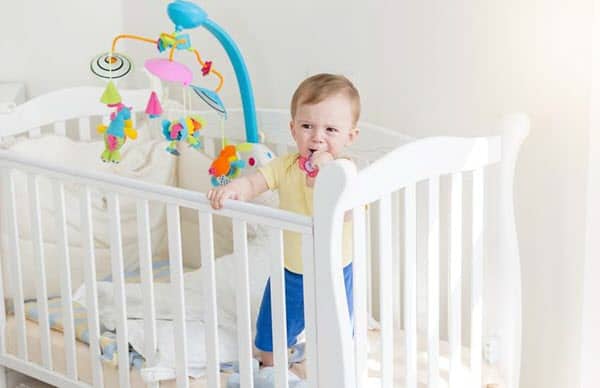 baby standing in the crib