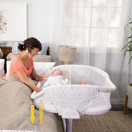 lowering the side of the HALO BassiNest Twin Sleeper bassinet