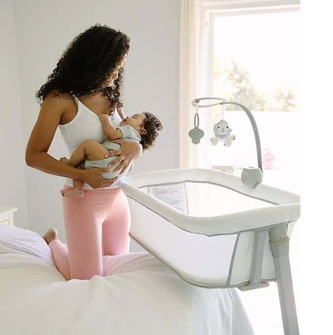 mom holding baby in the Arm's Reach The Versatile Co-Sleeper bassinet