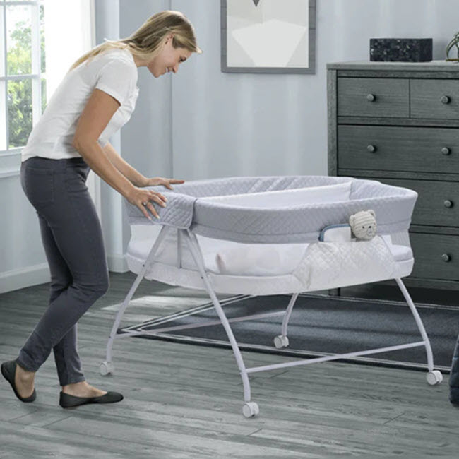 Mom with baby in Delta Twin Bassinet